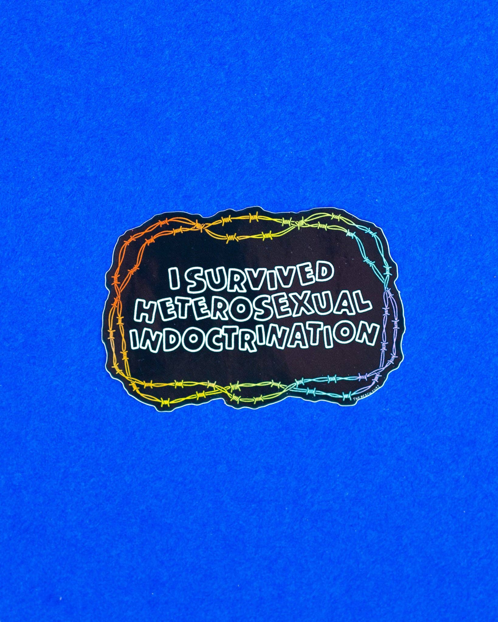 The Peach Fuzz I Survived Heterosexual Indoctrination Sticker (In Store Only)